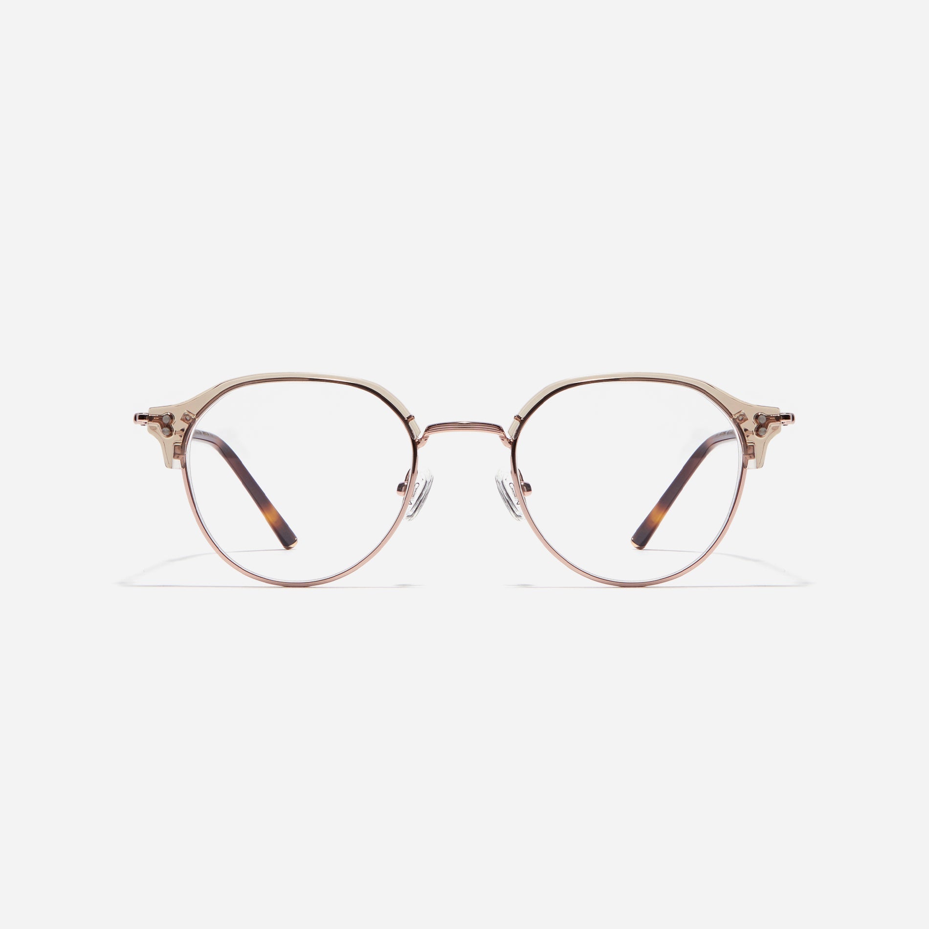 Polygonal-shaped gold-rimmed eyeglasses. The frame, constructed from bioplastic and titanium, seamlessly merges exceptional durability with an ultra-lightweight build, while stylish nose bridge lining details enhance the overall design. The B-titanium temples deliver a lightweight and comfortable fit, guaranteeing prolonged wear without any discomfort.