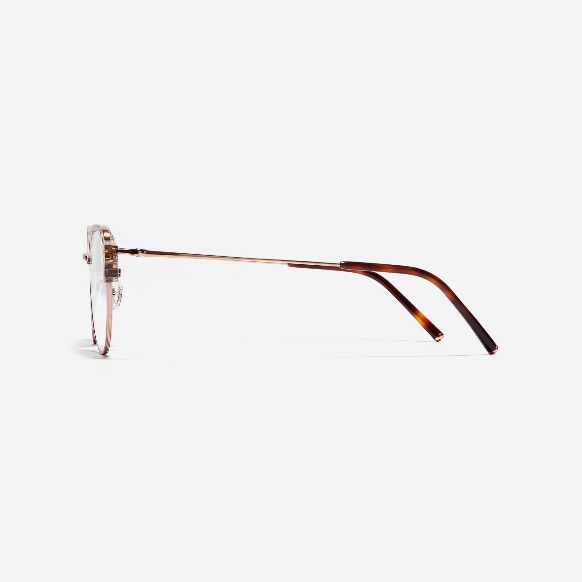 Polygonal-shaped gold-rimmed eyeglasses. The frame, constructed from bioplastic and titanium, seamlessly merges exceptional durability with an ultra-lightweight build, while stylish nose bridge lining details enhance the overall design. The B-titanium temples deliver a lightweight and comfortable fit, guaranteeing prolonged wear without any discomfort.