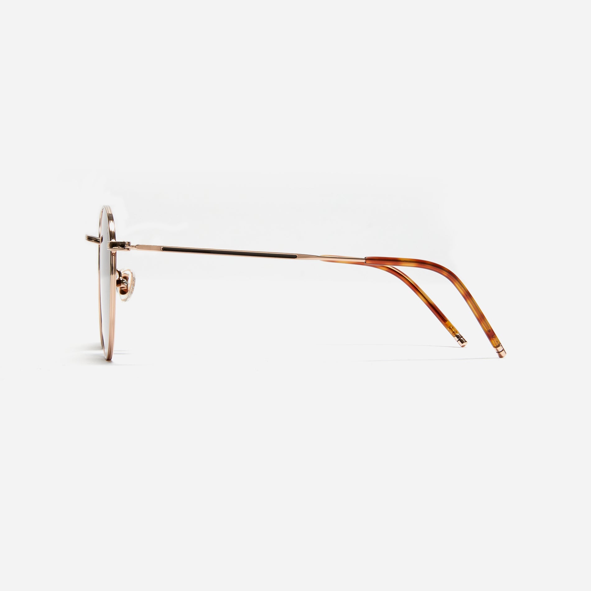 Round-shaped metal sunglasses that offer a soft and natural look with a peach-shaded titanium frame.