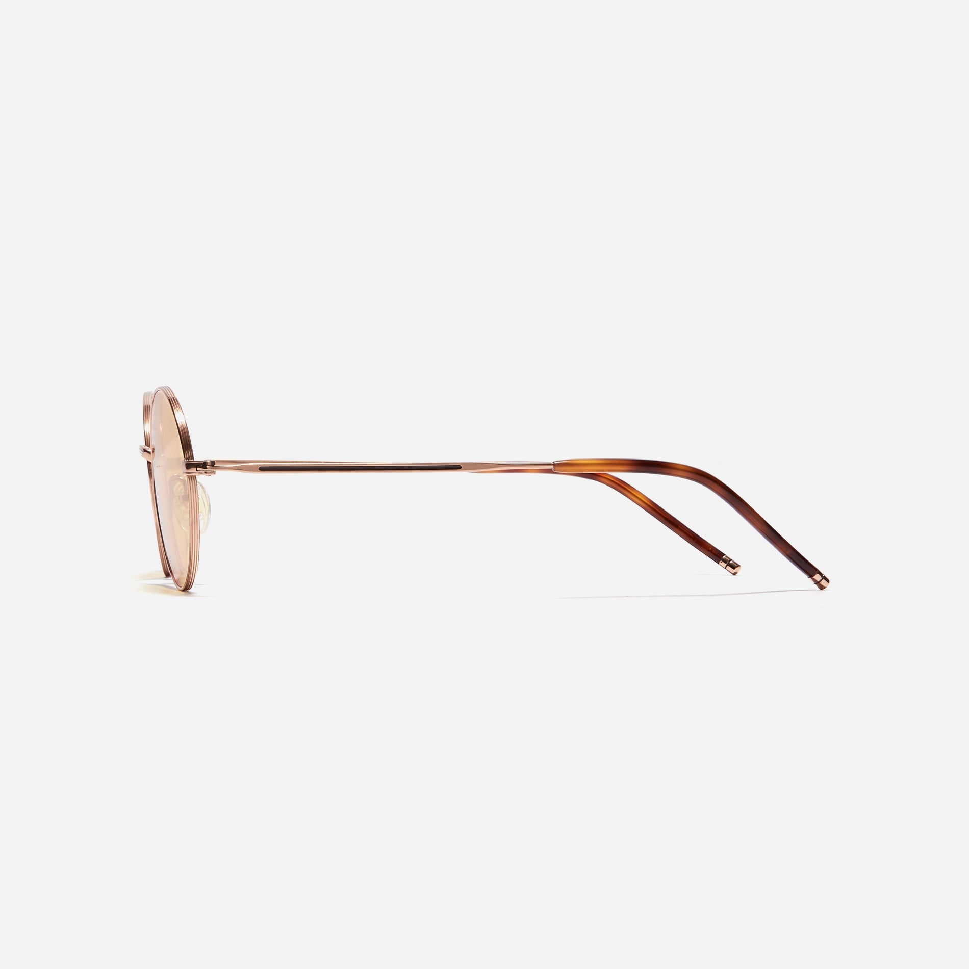 Tinted sunglasses with an oval frame crafted entirely from titanium.