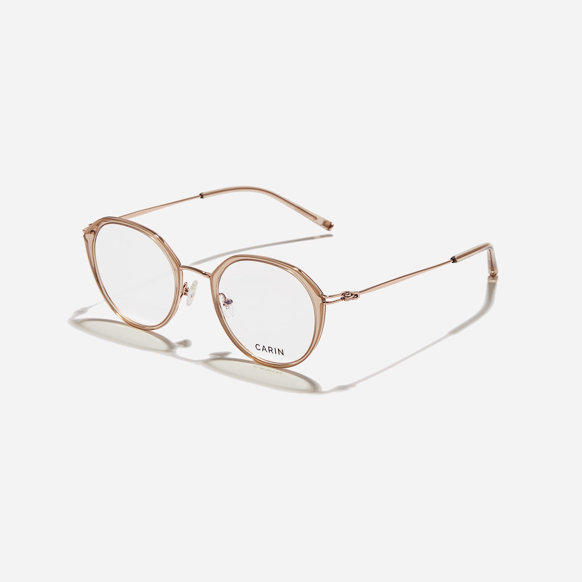 Polygonal-shaped eyeglasses that feature a contrasting round lens design, offering a smooth yet refined style. They provide a comfortable wearing experience with slim temples made from lightweight and elastic B-Titanium material.