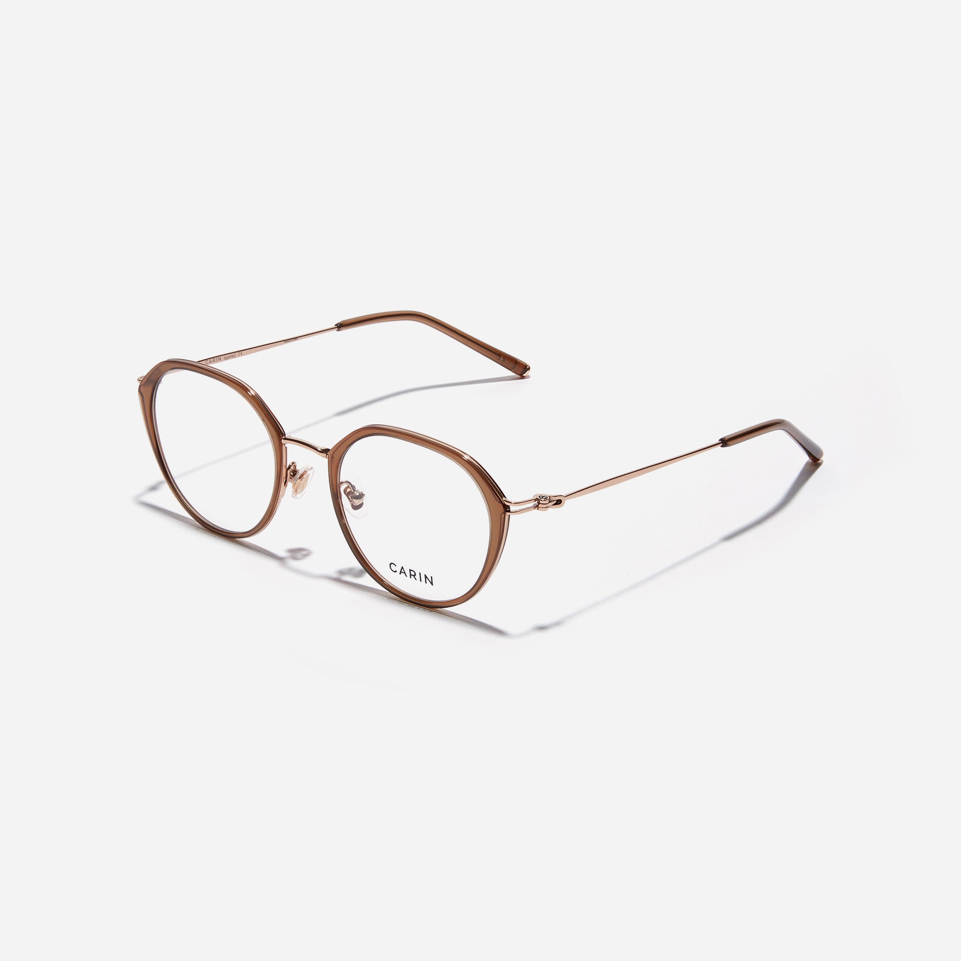 Polygonal-shaped eyeglasses that feature a contrasting round lens design, offering a smooth yet refined style. They provide a comfortable wearing experience with slim temples made from lightweight and elastic B-Titanium material.