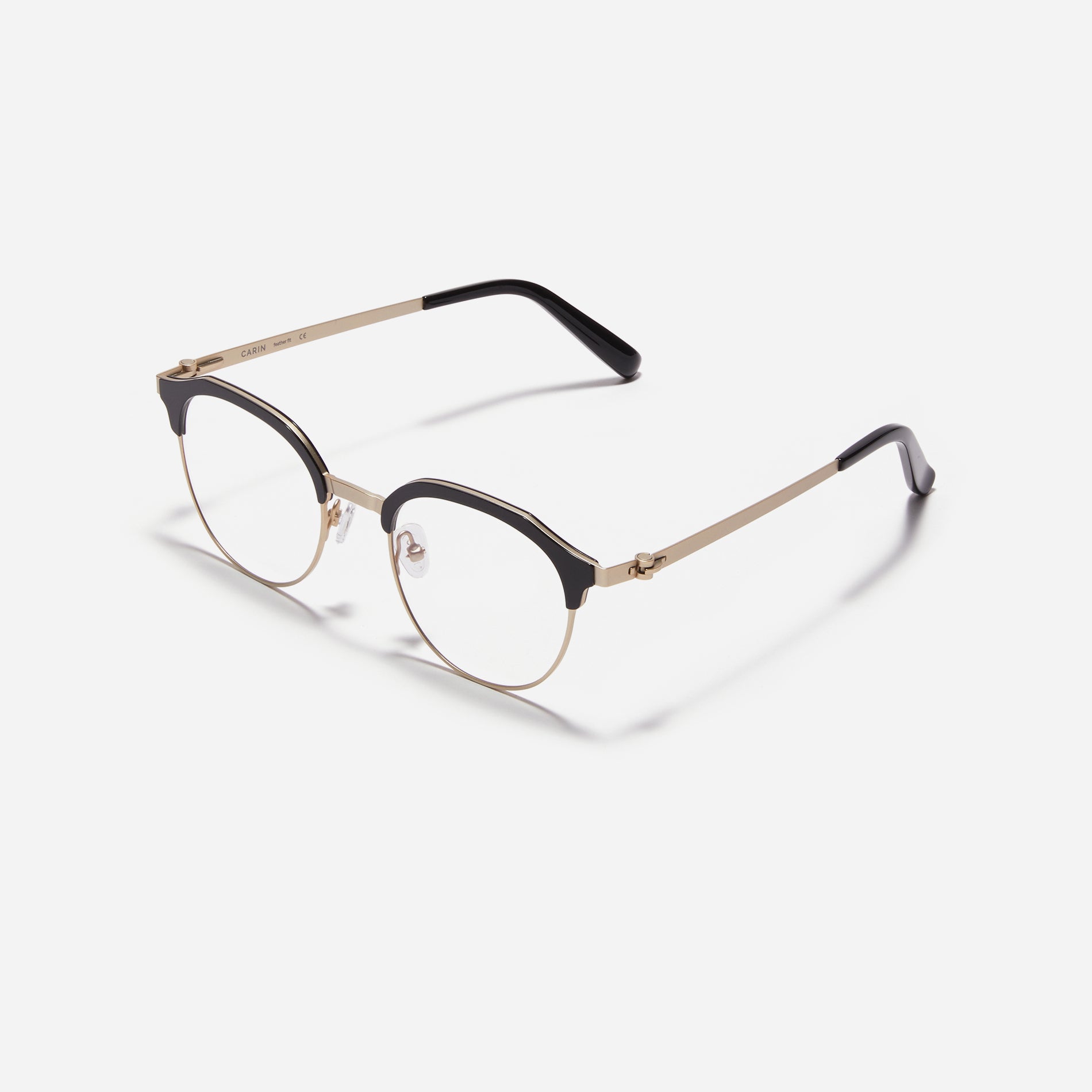 Lightweight polygon-shaped eyeglasses from CARIN's 'Feather Fit' line, offering a contemporary twist on the classic browline design.