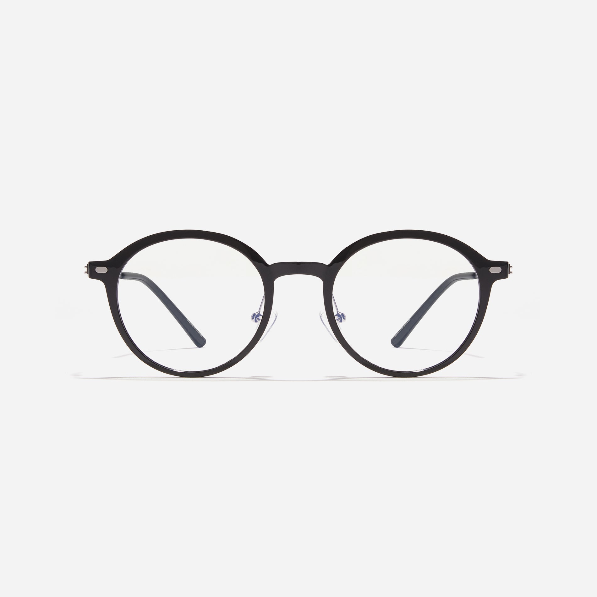 Round-shaped combination eyeglasses from CARIN's 'Feather Fit' line. Their combination frame seamlessly blends bio-plastic and titanium, utilizing advanced injection molding technology, often seen in the manufacturing of cell phones and watches.