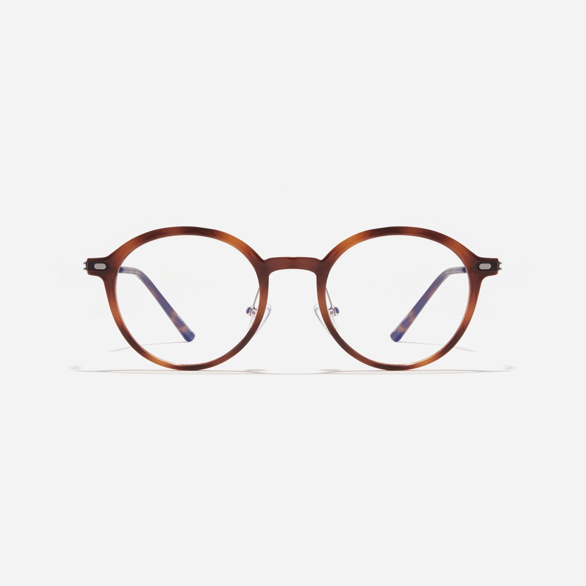 Round-shaped combination eyeglasses from CARIN's 'Feather Fit' line. Their combination frame seamlessly blends bio-plastic and titanium, utilizing advanced injection molding technology, often seen in the manufacturing of cell phones and watches.