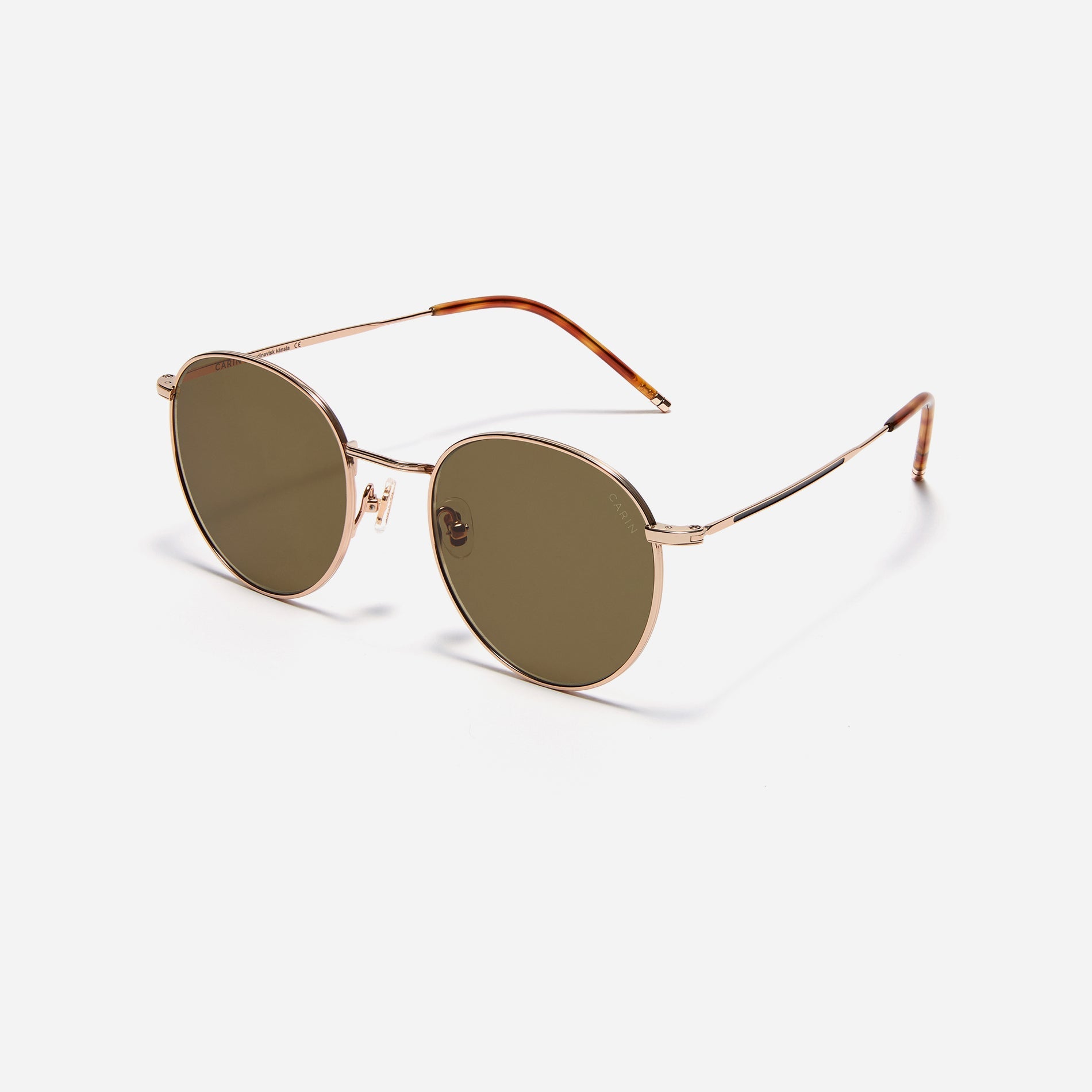 Round-shaped metal sunglasses that offer a soft and natural look with a peach-shaded titanium frame. 