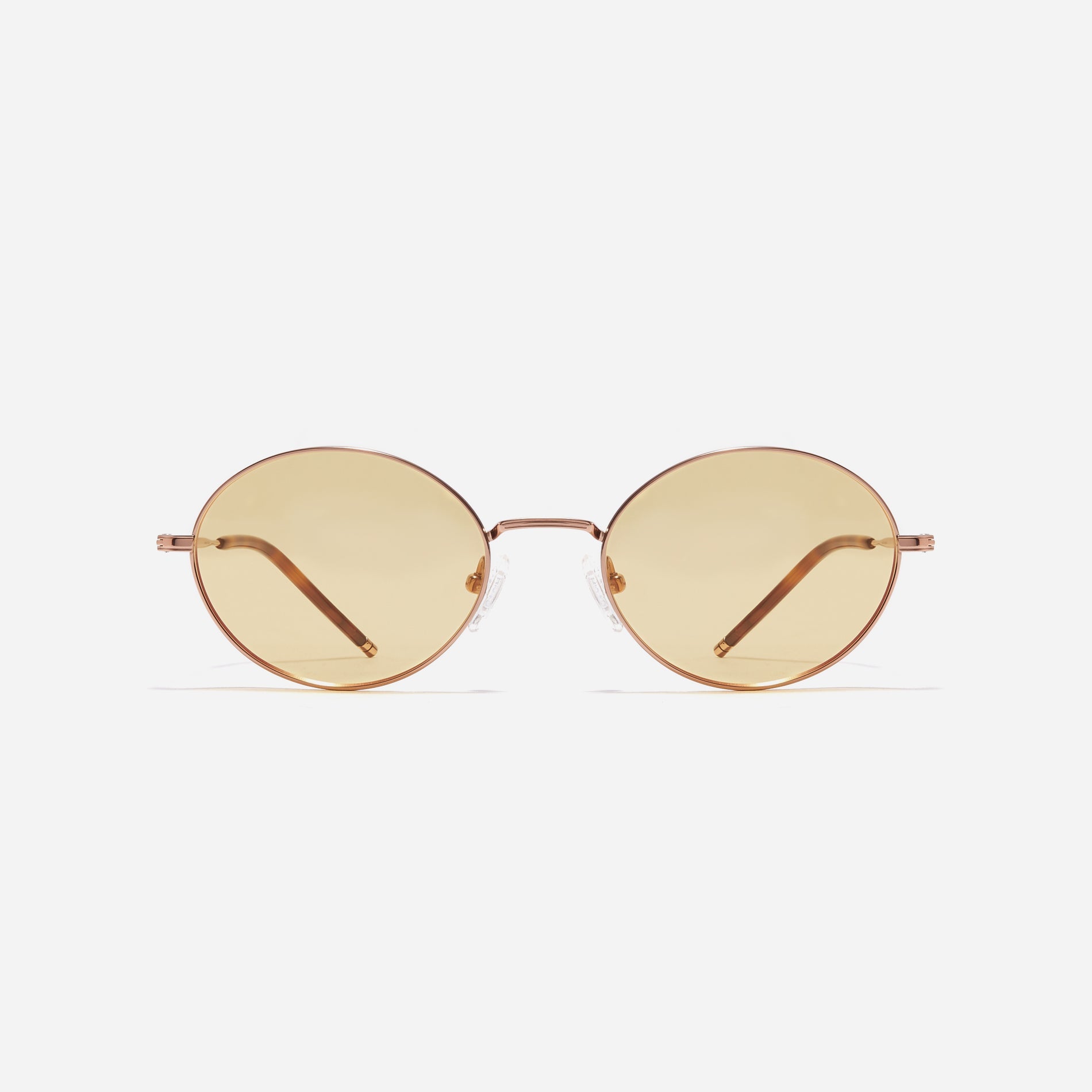 Tinted sunglasses with an oval frame crafted entirely from titanium.