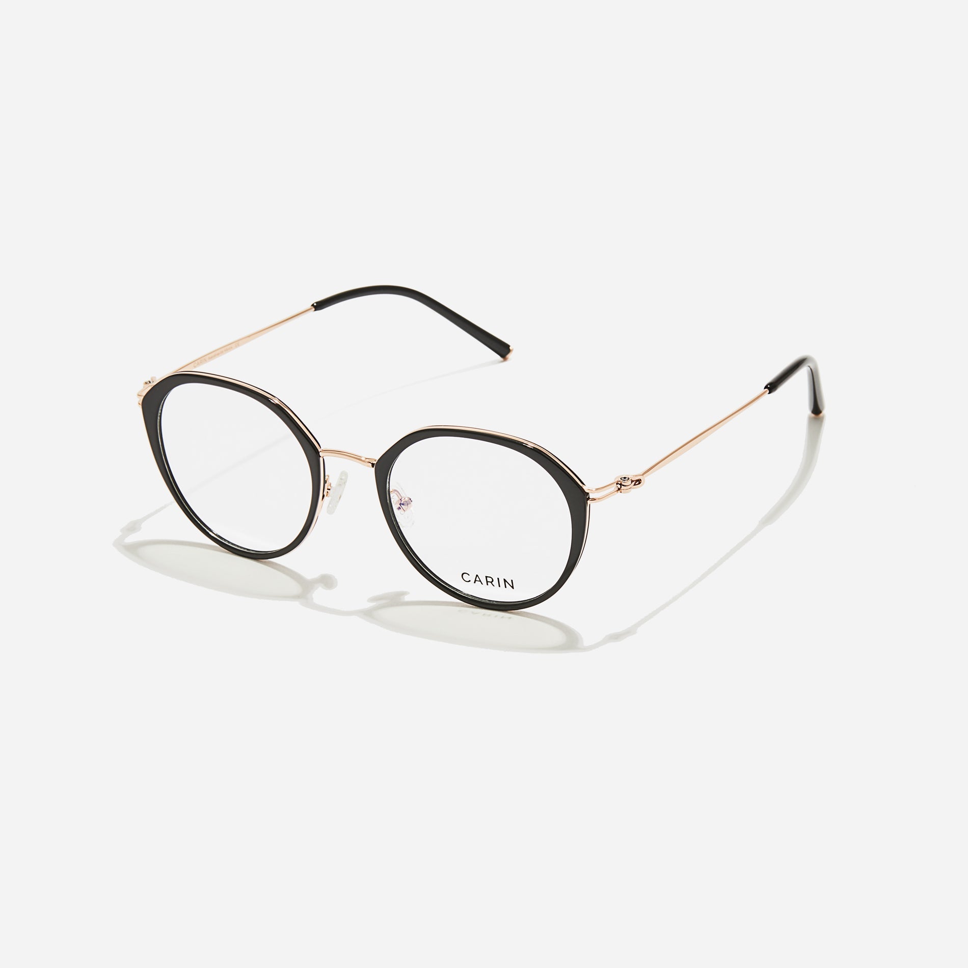 Polygonal-shaped eyeglasses that feature a contrasting round lens design, offering a smooth yet refined style.  They provide a comfortable wearing experience with slim temples made from lightweight and elastic B-Titanium material.