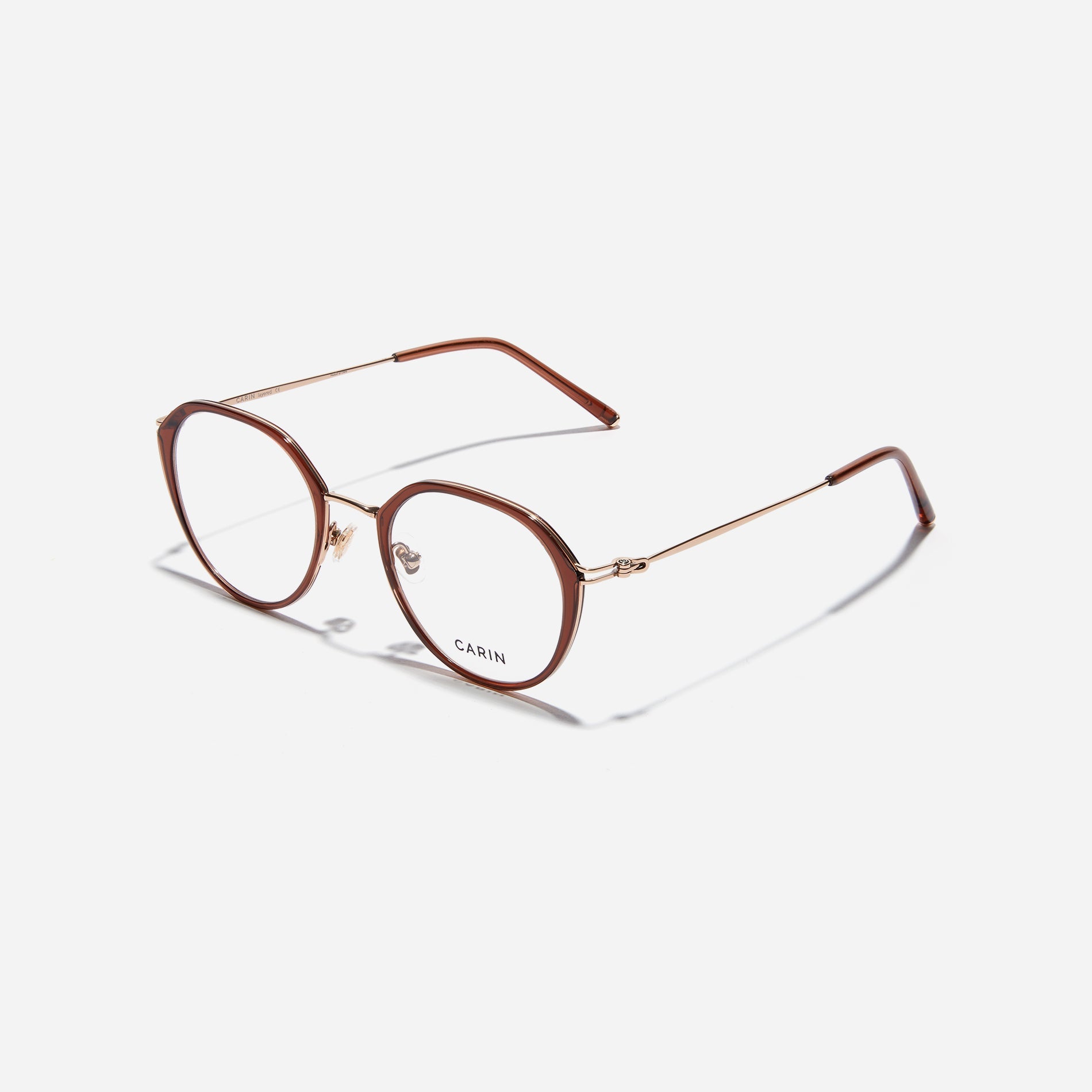 Polygonal-shaped eyeglasses that feature a contrasting round lens design, offering a smooth yet refined style.  They provide a comfortable wearing experience with slim temples made from lightweight and elastic B-Titanium material.