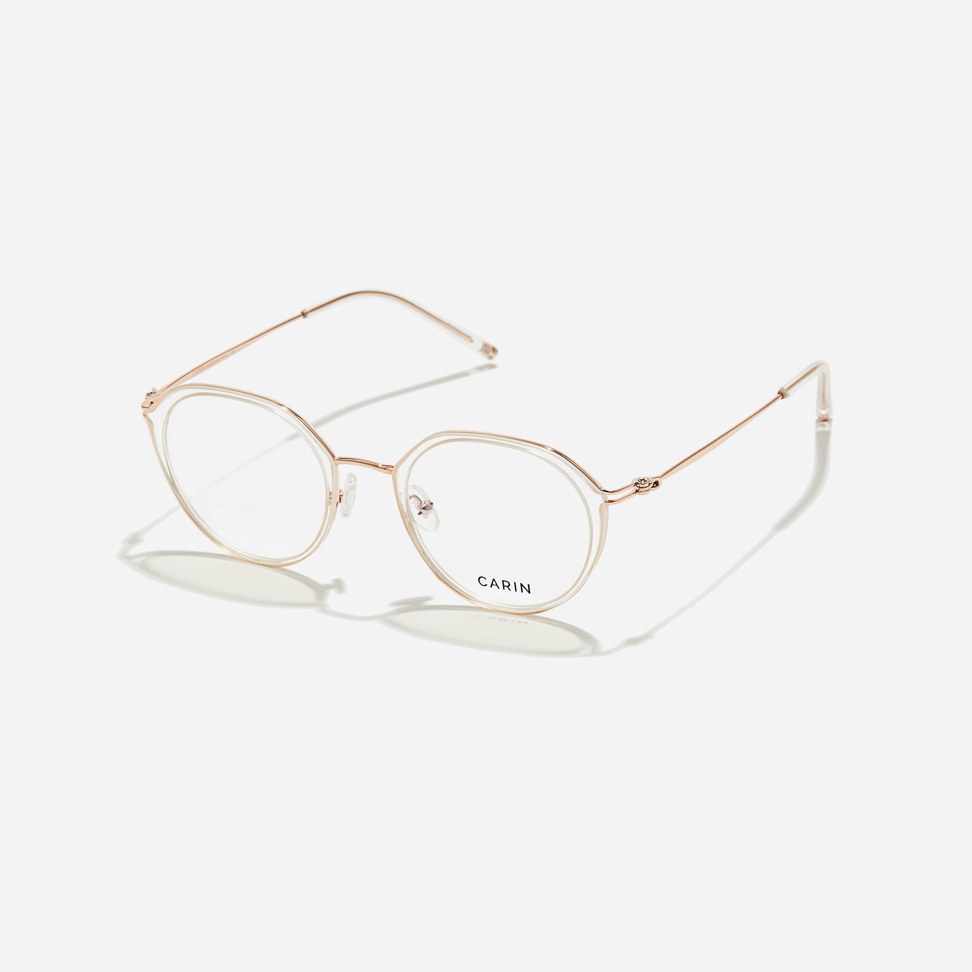 Polygonal-shaped eyeglasses that feature a contrasting round lens design, offering a smooth yet refined style.  They provide a comfortable wearing experience with slim temples made from lightweight and elastic B-Titanium material.